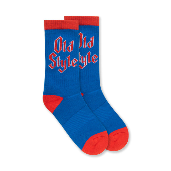 front of blue pair of mid calf socks with red old style words on it